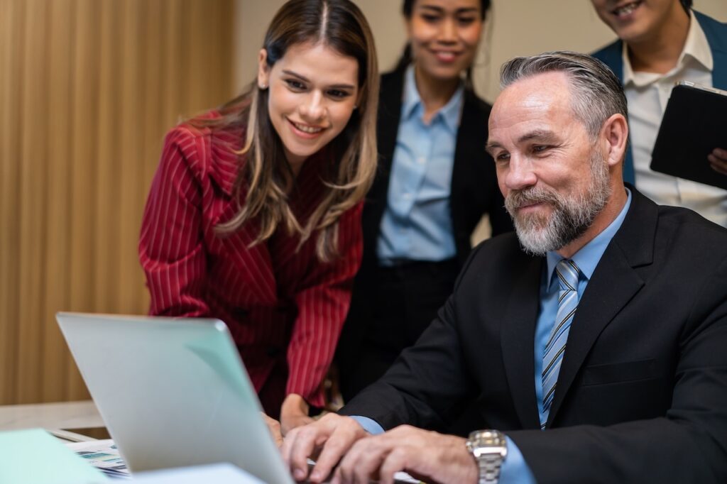 business owner looks at computer with cyber security expert
